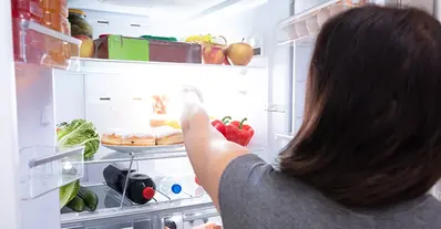 woman-taking-food-from-refrigerator.webp